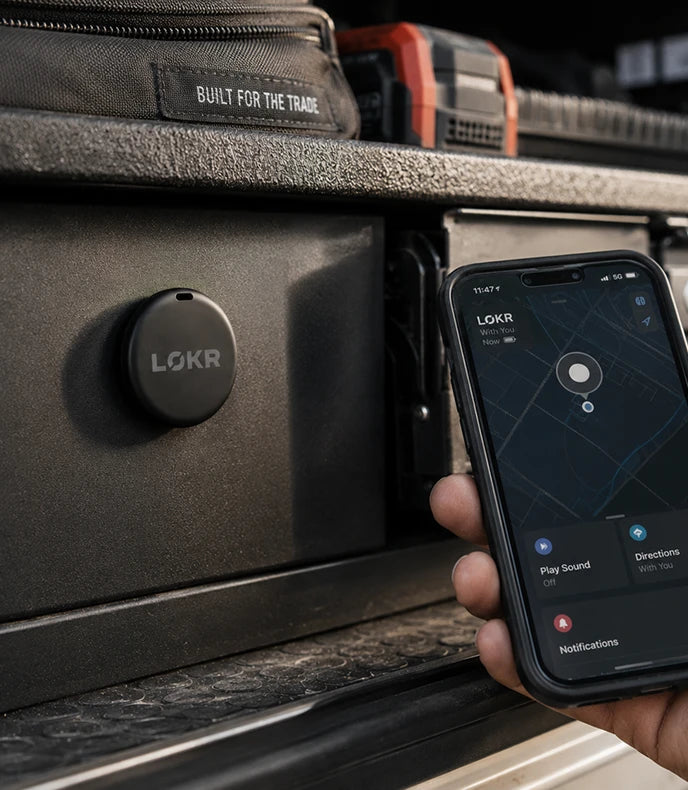 LOKR tracking tag mounted on a heavy metal storage drawer next to a hand holding a smartphone with a location map app open