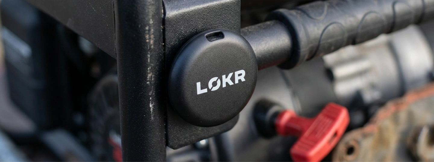 LOKR tracking tag is mounted onto a black metal frame of a generator or piece of machinery.
